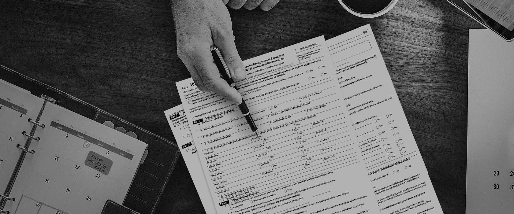 A hand pointing out parts of a form 1023